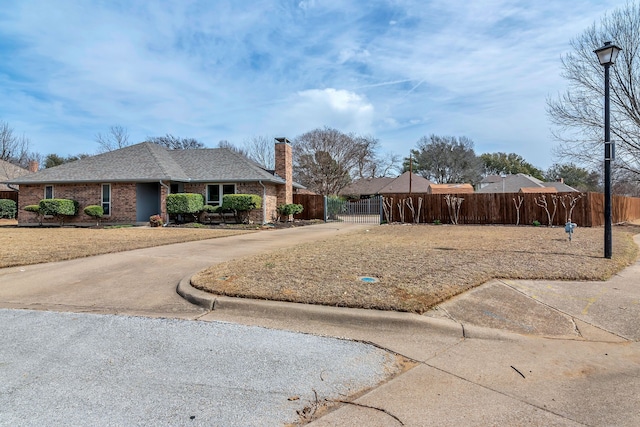 exterior space with driveway, a gate, and fence