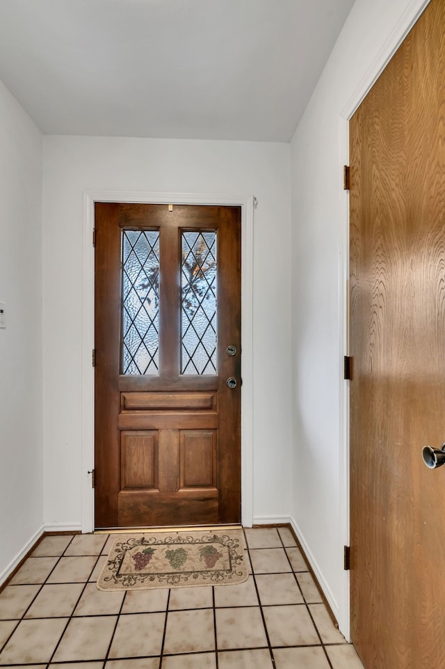 entrance foyer with baseboards and light tile patterned flooring