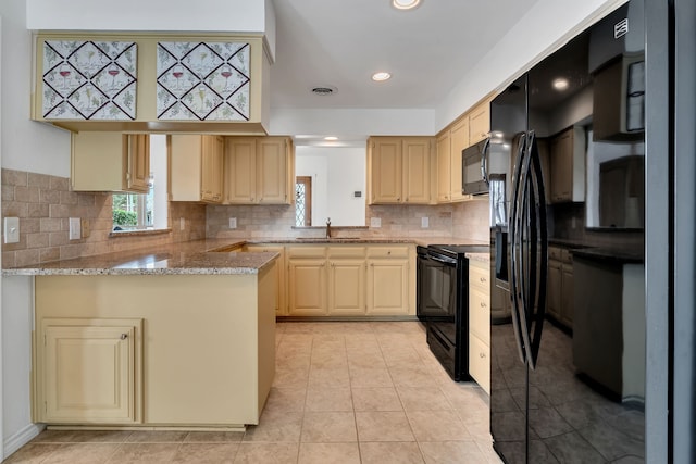 kitchen with light tile patterned flooring, a peninsula, visible vents, black appliances, and tasteful backsplash