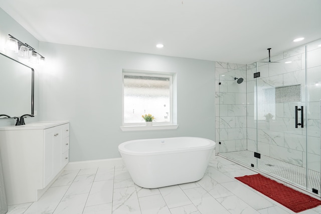 bathroom with a freestanding tub, vanity, baseboards, marble finish floor, and a shower stall