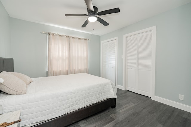 bedroom with multiple closets, dark wood finished floors, baseboards, and ceiling fan