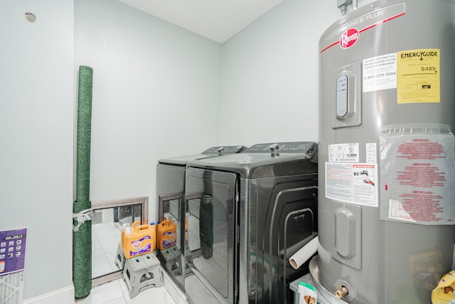 laundry area with laundry area, water heater, and washer and clothes dryer