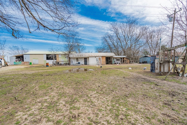 view of front of property with an outbuilding and a front lawn