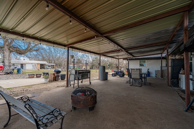 view of patio with an outdoor fire pit and outdoor dining area