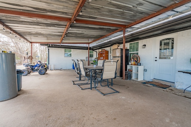 view of patio with water heater and outdoor dining space