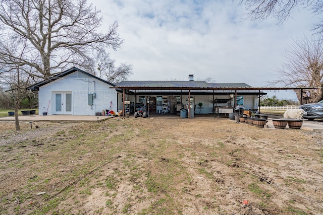 rear view of house with an outbuilding and french doors