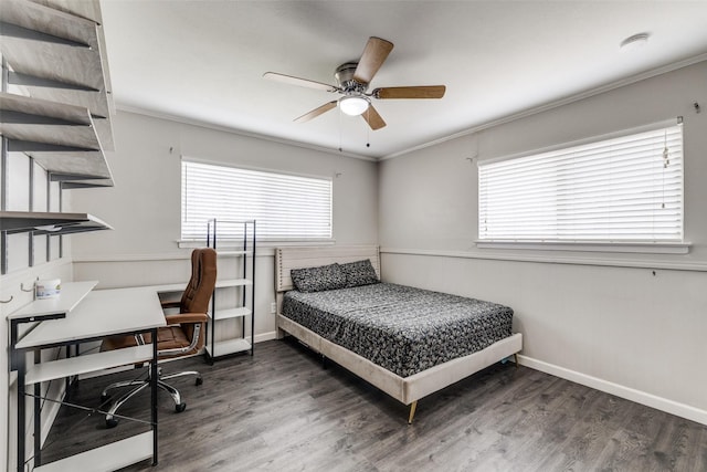 bedroom with ornamental molding, multiple windows, wood finished floors, and baseboards