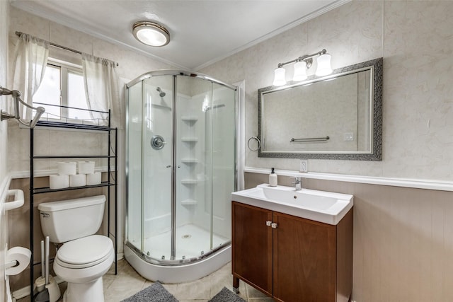 full bath with toilet, a stall shower, crown molding, and vanity