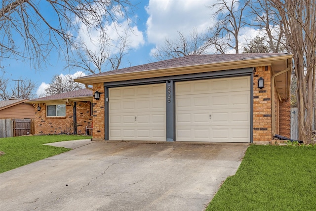 garage featuring driveway and fence