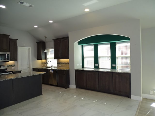 kitchen with stone counters, stainless steel appliances, recessed lighting, visible vents, and backsplash