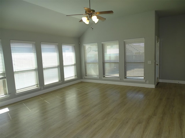 unfurnished sunroom with ceiling fan and vaulted ceiling