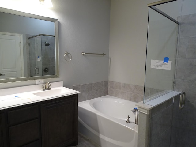 bathroom featuring vanity, a shower stall, a bath, and tile patterned floors