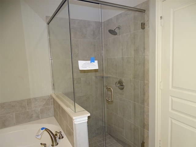 full bath featuring a stall shower and a garden tub