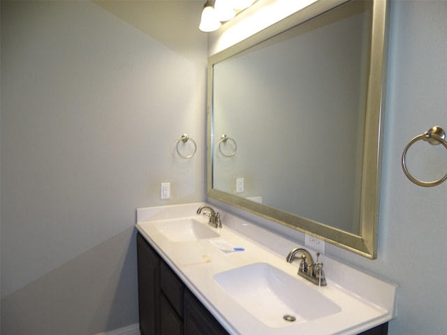 full bathroom featuring double vanity and a sink