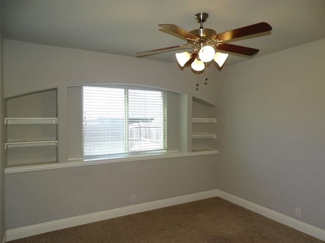 unfurnished room with a ceiling fan, carpet flooring, and baseboards