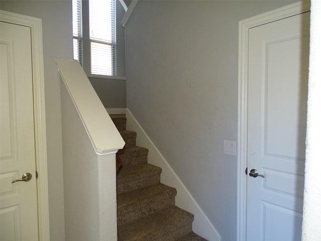 stairs featuring baseboards