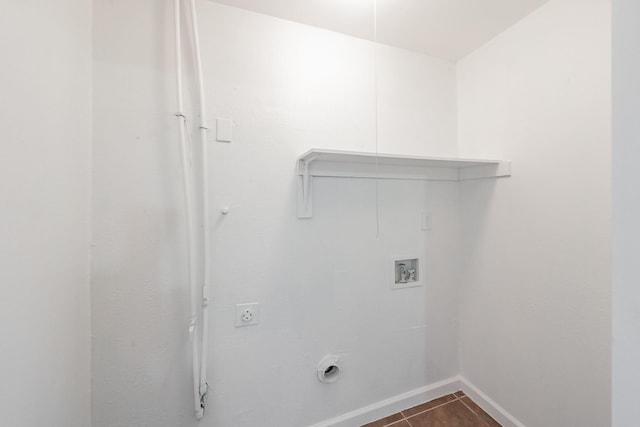 laundry area featuring baseboards, dark tile patterned floors, washer hookup, laundry area, and hookup for an electric dryer