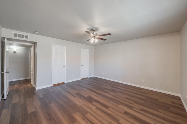 unfurnished bedroom featuring visible vents, ceiling fan, dark wood-type flooring, and baseboards