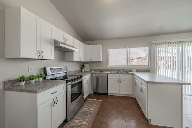 kitchen with dark tile patterned flooring, under cabinet range hood, white cabinetry, appliances with stainless steel finishes, and a peninsula