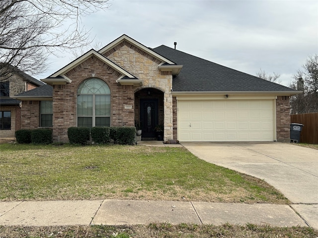 view of front of home featuring an attached garage, concrete driveway, a front yard, and roof with shingles