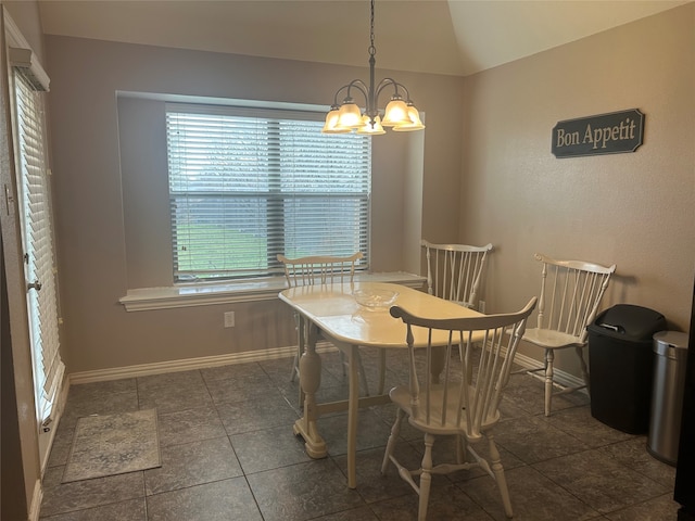 dining room featuring baseboards, an inviting chandelier, tile patterned flooring, and vaulted ceiling