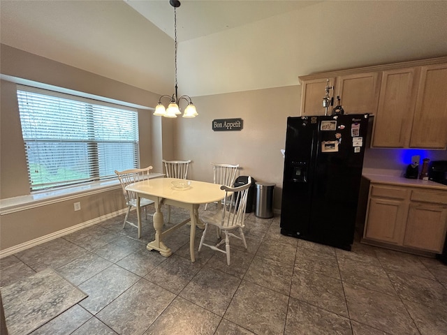 dining space featuring an inviting chandelier, baseboards, and lofted ceiling