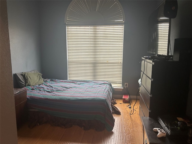 bedroom featuring light wood-type flooring and baseboards