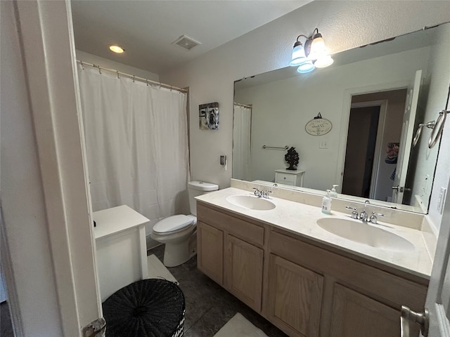 full bathroom with double vanity, visible vents, toilet, and a sink