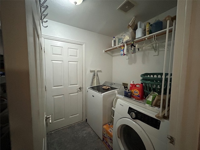 washroom with washer and clothes dryer, laundry area, and visible vents