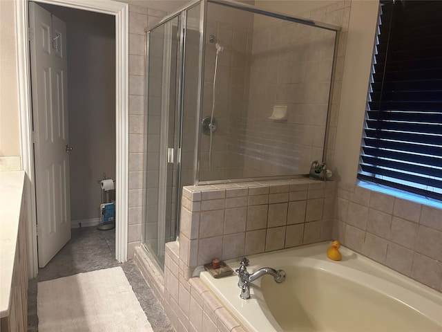 bathroom featuring a shower stall and a garden tub