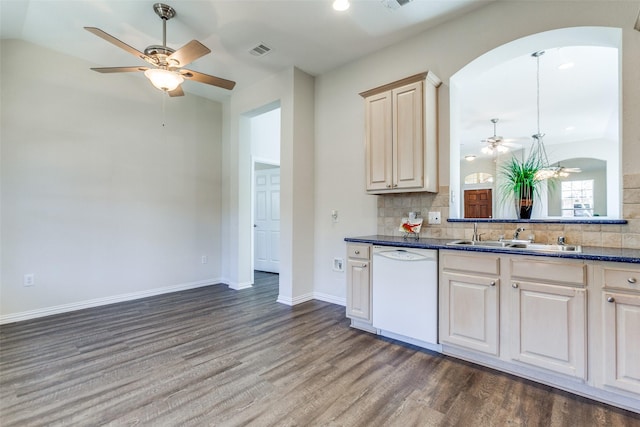 kitchen with visible vents, a sink, backsplash, wood finished floors, and white dishwasher