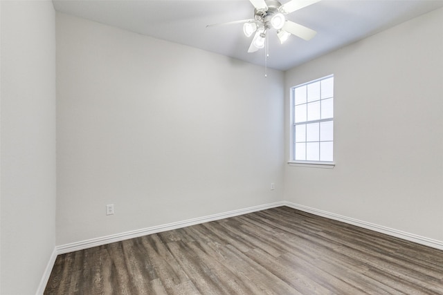 empty room with baseboards, wood finished floors, and a ceiling fan