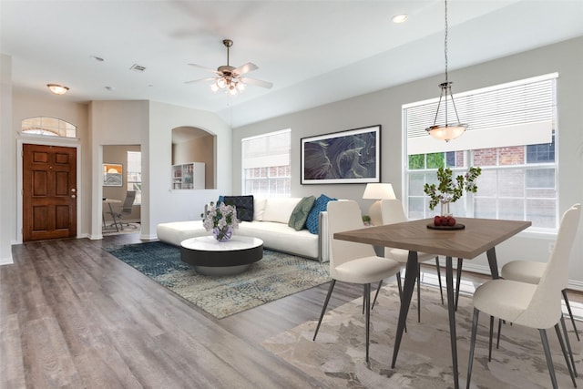 living room featuring wood finished floors, baseboards, recessed lighting, arched walkways, and ceiling fan