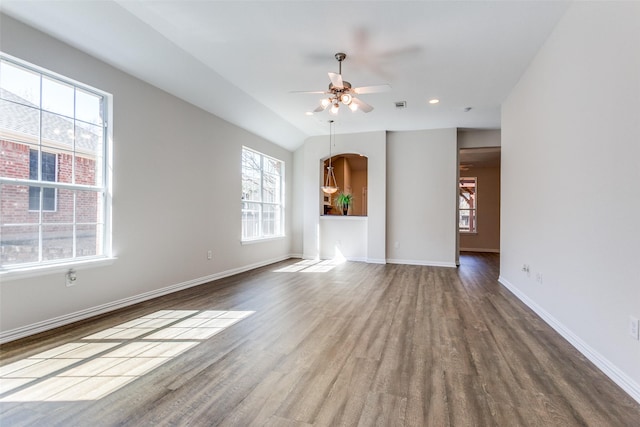 spare room featuring visible vents, a ceiling fan, baseboards, and wood finished floors