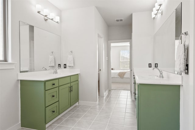 ensuite bathroom with two vanities, visible vents, a sink, and tile patterned floors