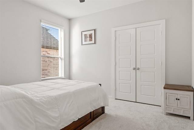 bedroom featuring a ceiling fan, a closet, and carpet flooring