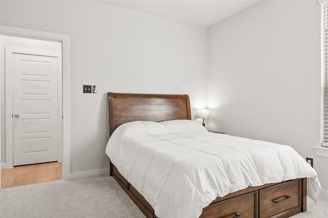 carpeted bedroom with baseboards