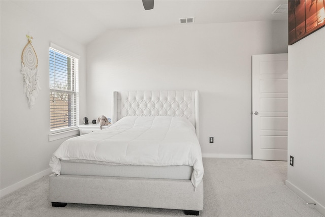 carpeted bedroom featuring lofted ceiling, baseboards, visible vents, and a ceiling fan