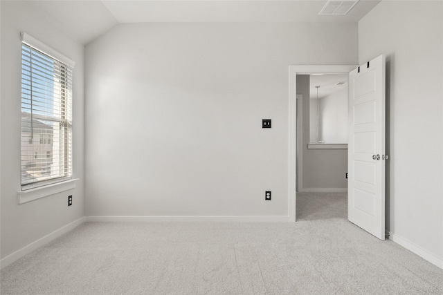 unfurnished bedroom featuring lofted ceiling, light carpet, visible vents, and baseboards