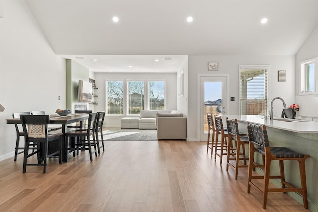 dining area with a healthy amount of sunlight, light wood-style flooring, and recessed lighting