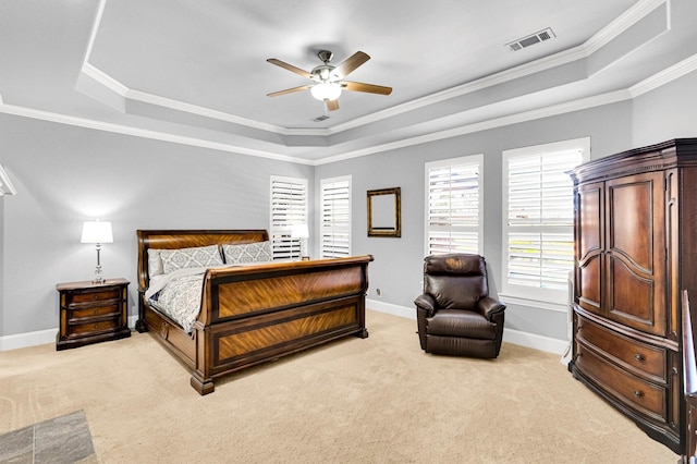 bedroom featuring light carpet, a tray ceiling, visible vents, and baseboards