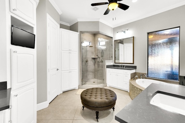 bathroom with two vanities, ornamental molding, a stall shower, a sink, and tile patterned flooring