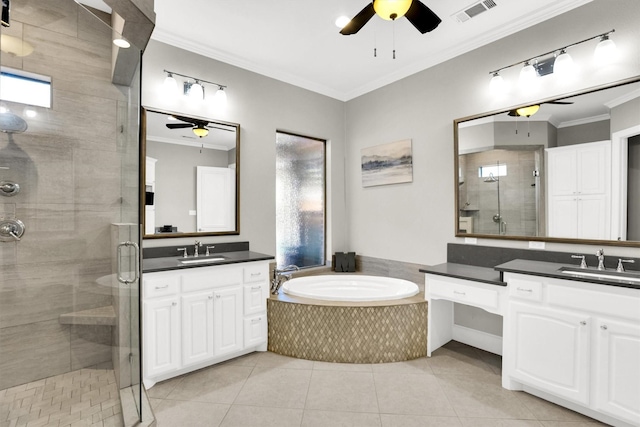 bathroom with a stall shower, crown molding, visible vents, and a sink