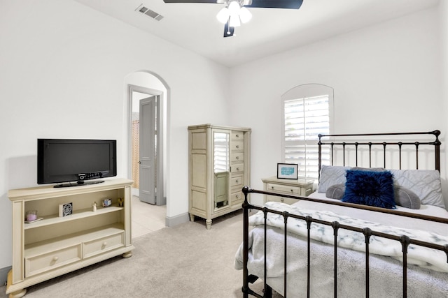 bedroom featuring light carpet, ceiling fan, and visible vents