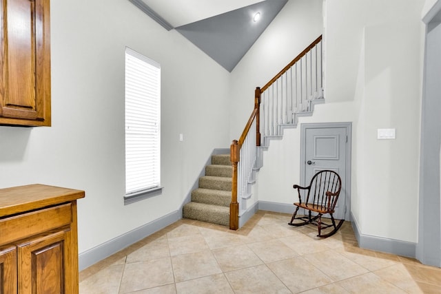 stairway with tile patterned flooring, a healthy amount of sunlight, and baseboards