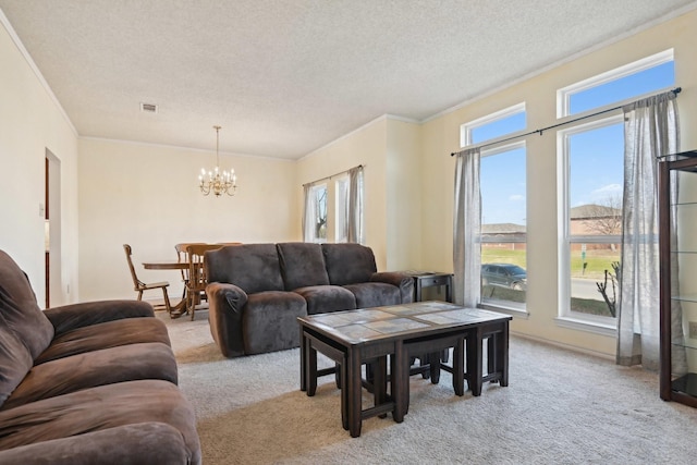 living room featuring crown molding, a notable chandelier, light colored carpet, and a textured ceiling