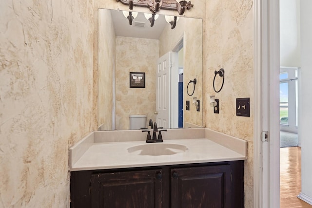 bathroom featuring toilet and vanity