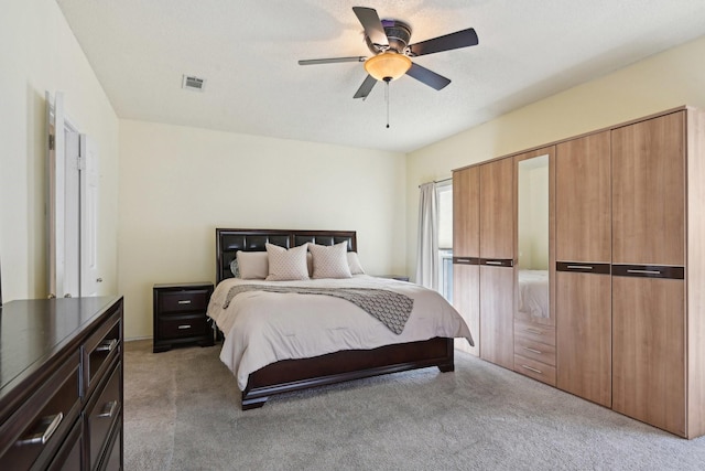 bedroom featuring light carpet, visible vents, and ceiling fan