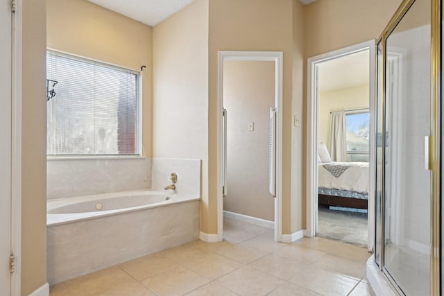 ensuite bathroom featuring ensuite bath, plenty of natural light, and tile patterned floors