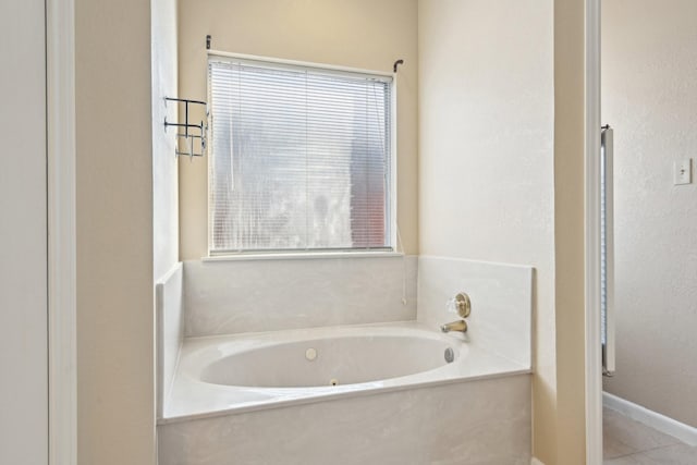 full bathroom featuring tile patterned flooring and a tub with jets